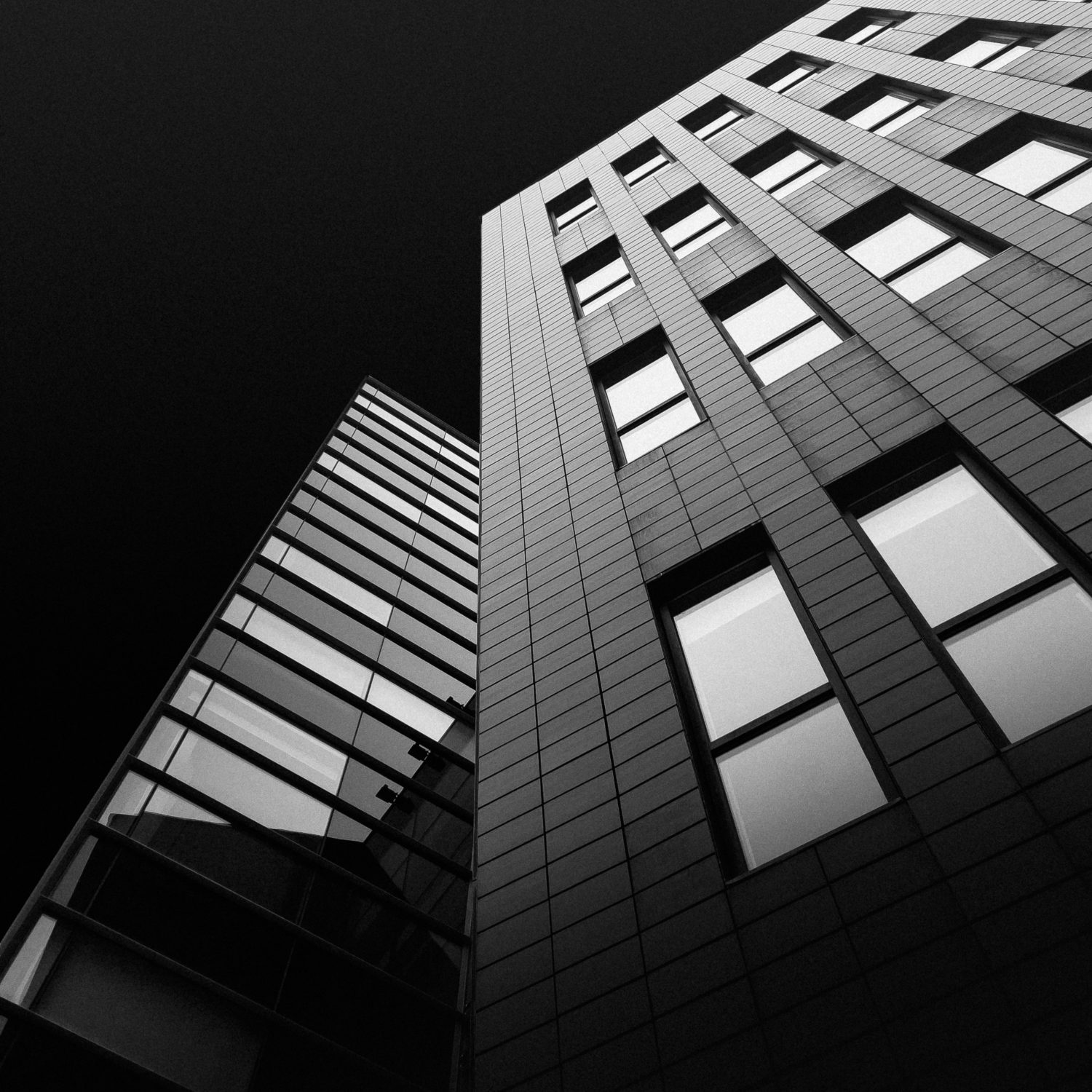Black and white building facade looking upward