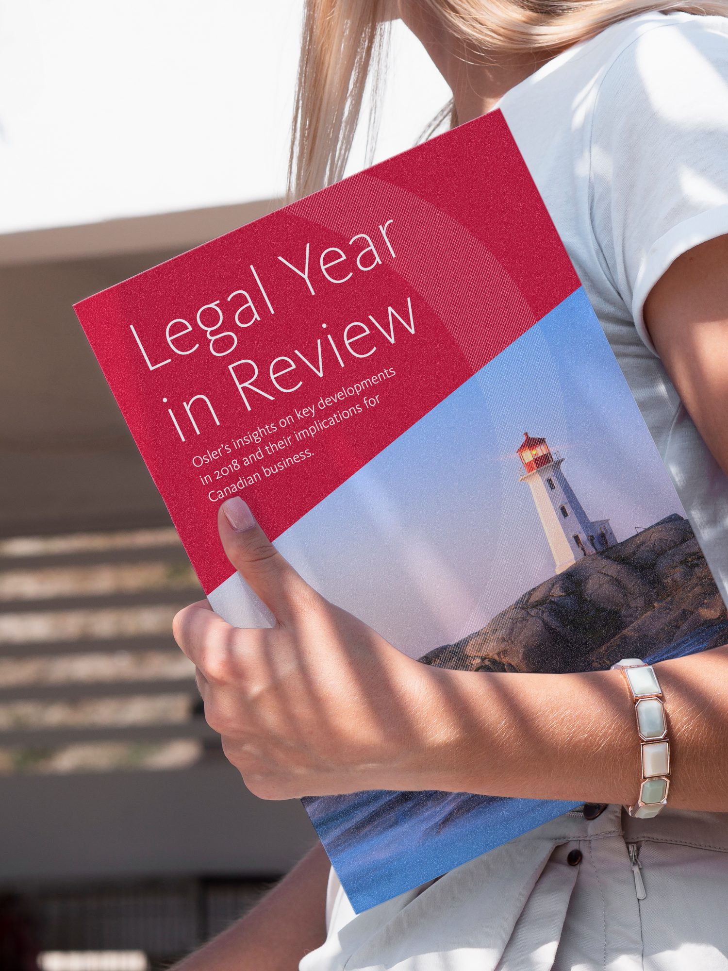 Person holding the Osler Legal Year in Review publication